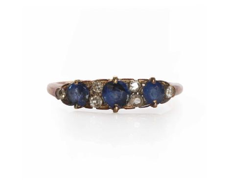 A graduated three stone sapphire boat shaped ring, the central round mixed cut sapphire flanked by two old eight cut diamonds