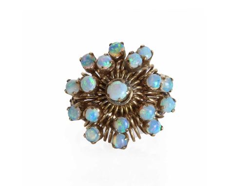 A gold and opal abstract design ring, the wire work ring head designed as a three-tier spray, set with circular cabochon opal