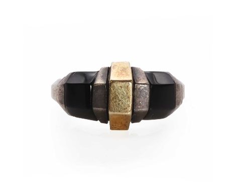 A sterling silver gold and onyx ring, by Cartier,the geometric design ring head centring an angular gold section, flanked by 