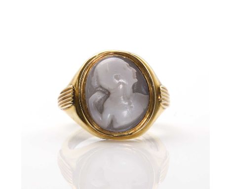 A gold mounted shell cameo ring, with an oval carved shell cameo depicting a man's head and upper torso in pugilistic stance,