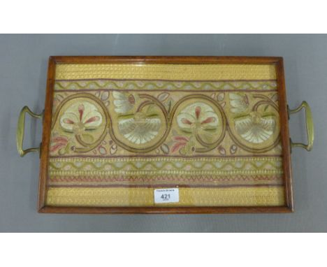 Rectangular glazed tray containing a Leek Society style embroidered festoon panel,  size overall 46 x 25cm