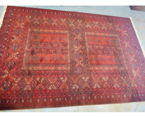 Louis de Poortere Mossoul wool carpet, the terracotta red field with four sections containing geometric motifs, 350 x 505cm 