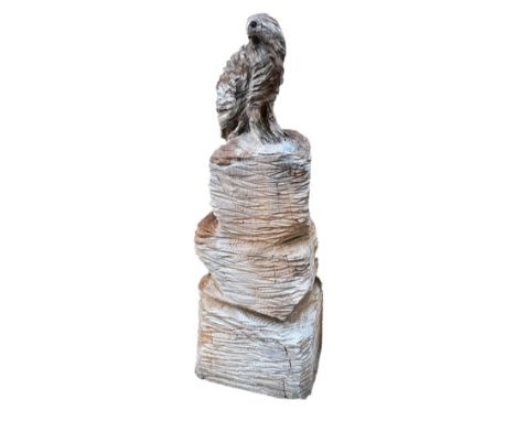 A chainsaw carving of an eagle on an outcrop, height 127cm