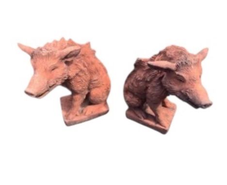 A pair of terracotta seated wild boar garden ornaments, height 55cm