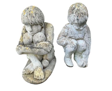 Two reconstituted stone seated child garden ornaments, larger height 56cm