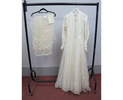 A Circa 1950'S Wedding Dress, the cream damask fitted bodice with centre front button fastening and long fitted sleeves to fu