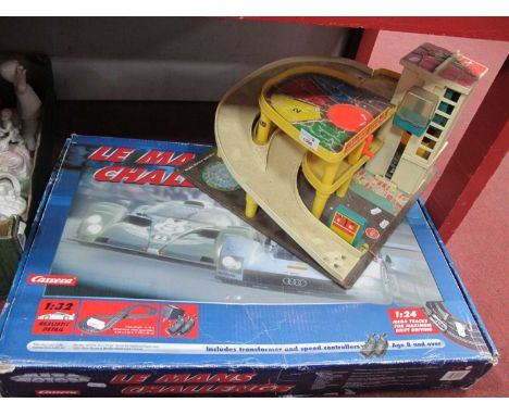 A Carrera Megaslot Racing Le Mans Challenge boxed set 1/32 scale together with a Fisher Price Parking Ramp Service Centre, pl