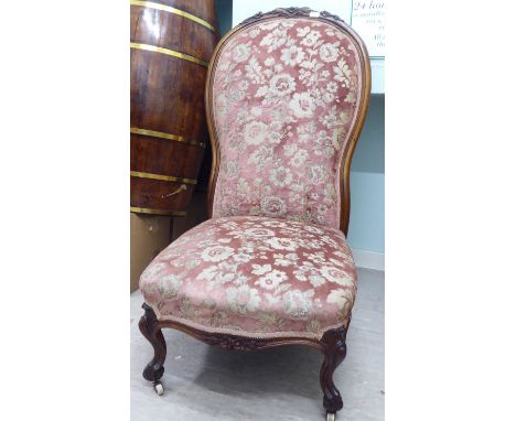 A mid 19thC Continental rosewood framed salon chair with a floral fabric upholstered back and seat, raised on cabriole legs&n