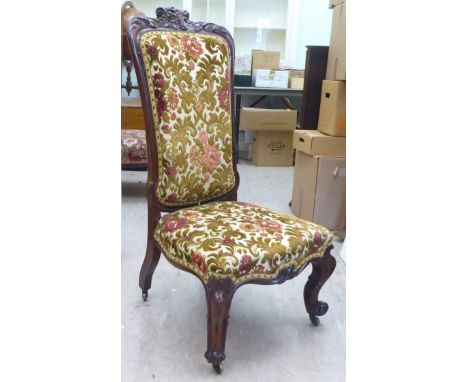 A mid 19thC Continental rosewood framed salon chair with a floral fabric upholstered back and seat, raised on cabriole legs&n