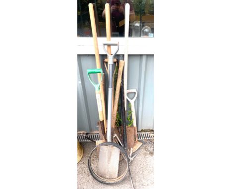 Selection of garden tools to include pick axes, post hole diggers, spades etc. 