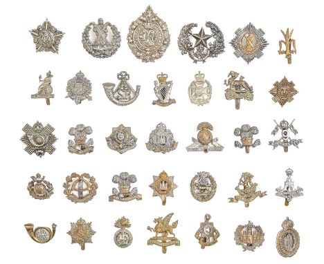 An extensive collection of British army metal cap badges, including many regiments and corps, an ARP badge and two reference 