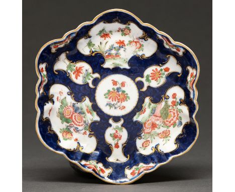 A Worcester scale blue ground teapot-stand, c1770, painted with reserves of chrysanthemums and other flowers, 14 x 14cm, pain