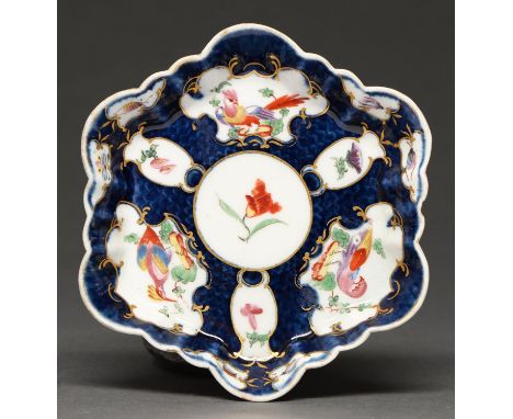 A Worcester scale blue ground teapot stand, c1770, painted with reserves of 'dishevelled' birds and flowers, 12.5 x 14.5cm, p