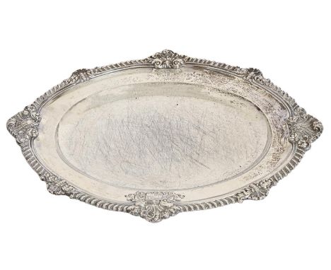 A Victorian silver second course dish, the gadrooned rim with shells at intervals, engraved with contemporary armorials, 43cm