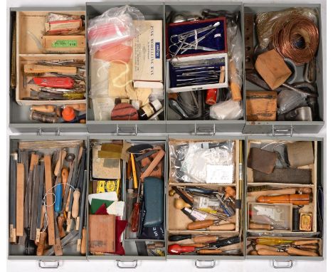 A metal cabinet with eight graduated drawers,&nbsp;enclosing miscellaneous tools, including wooden-hafted files, some measure