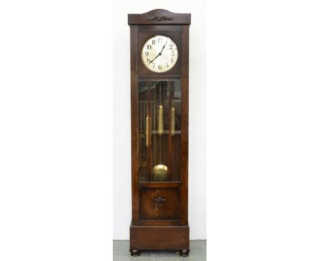 An oak longcase clock, c1930, the three train movement with silvered dial, weights and pendulum, 200cm h Complete and origina