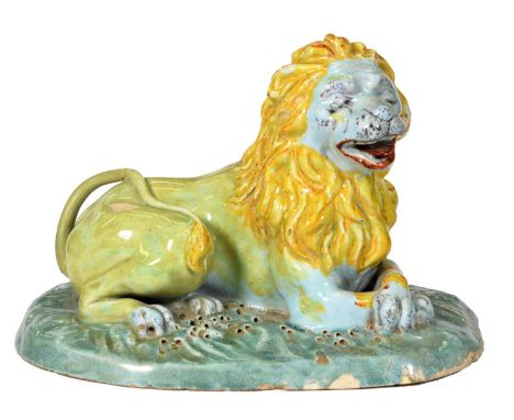 A Northern European tin glazed earthenware model of a lion, late 18th c, painted predominantly in yellow and light blue with 
