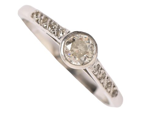 A diamond ring, with larger central collet and diamond shoulders, in platinum marked PLAT, 3.6g, size P Light wear