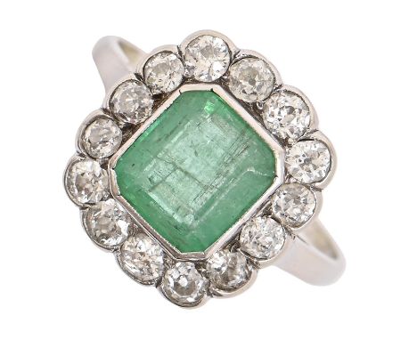 An emerald and diamond cluster ring,&nbsp; the step cut emerald 7 x 8mm, in white gold, 3.5g, size O Emerald with slight scra