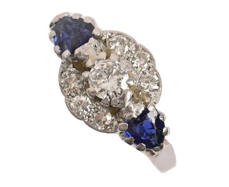 A sapphire and diamond ring, the central cluster flanked by heart shaped sapphires, gold hoop marked 18ct PLAT, 5.6g, size N 