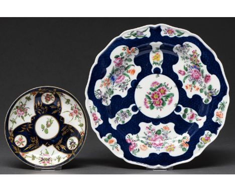 A Worcester scale blue ground plate, c1770, painted with flowers in shaped reserves, 22.5cm diam, painted fretted square in u