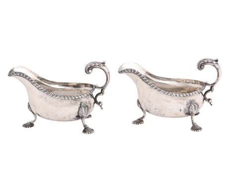 A pair of Edwardian silver sauceboats, with leaf capped flying scroll handle, on three shell feet, 10.5cm h, maker H&amp;S, L