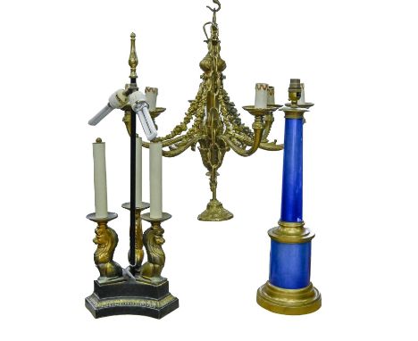 A brass mounted blue foiled glass table lamp, an Empire style bronzed metal three lion lamp and a gilt lacquered brass chande