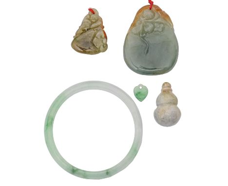 A jade bangle and thee other items 