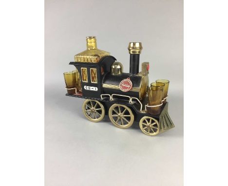 GLASS DECANTER AND SHOT GLASS SET,set within a model train, along with two decorative ceramic pineapples, six vintage wood an