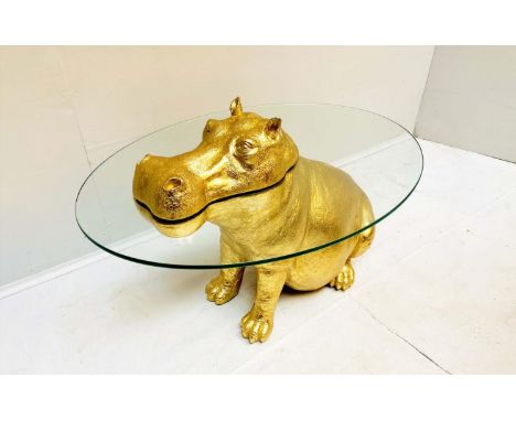 LOW TABLE, 65cm high, 50cm wide, 45cm deep, in the form of a Hippo in water, glass top and gilt resin base, Regency style. 