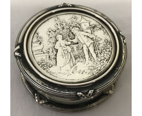 A continental 800 silver lidded trinket pot with classical scene to lid. Ribbed upper and lower rims with cross over detail. 