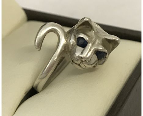 A 925 silver ring in shape of a cat. Set with 2 small sapphires for eyes.  Size L