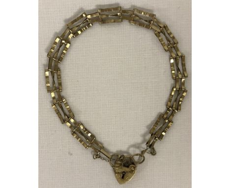 A 9ct gold 3 bar gate bracelet. With small padlock fastening and safety chain. Approx weight 3.5g.