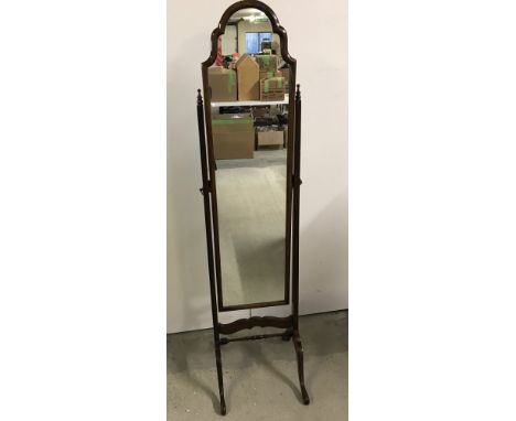A vintage dark wood framed cheval mirror. With shaped top, turned stretcher and finial detail. Approx. 40cm wide x 160cm tall