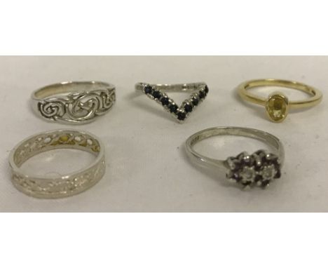 5 x silver rings of different designs. Comprising: Wishbone ring set with 9 sapphires, size J.  Vintage ring set with red &am