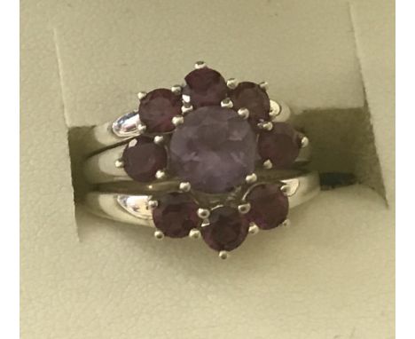 A set of 3 stone set 925 silver dress rings. Middle ring set with central amethyst and 2 deep pink stones. 2 other rings set 