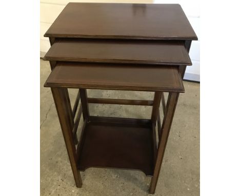 A nest of 3 mahogany inlaid tables with straight legs. Smallest table has under shelf. 