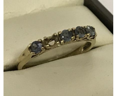 9ct gold dress ring set with 4 blue/green stones. One stone missing.  Size L½ approx. Weight approx  1.7g