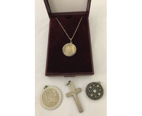 A small collection of silver and white metal jewellery. Comprising a silver cross pendant with engine turned decoration, silv
