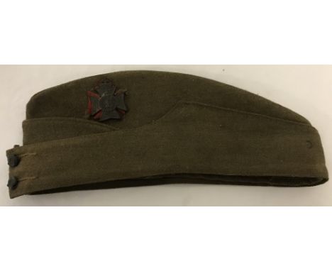 An original WW2 Buckinghamshire Battalion khaki side cap. Dated 1943. With Regimental badge over red felt to side, and 2 Ligh