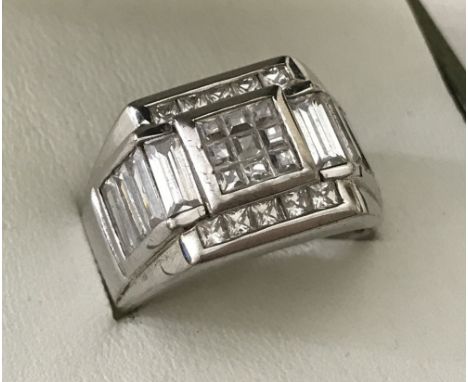 A men 925 silver ring. Square shaped, set with square and oblong cut clear stone. Ring size Q Total weight 11.1g.