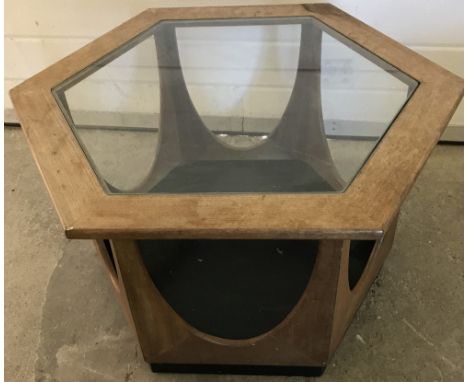 A vintage wooden framed hexagonal coffee table with glass insert top. With shaped sides, black base and under shelf. Approx. 