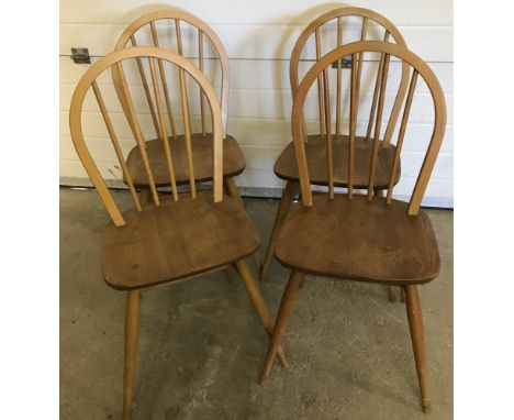 A set of 4 blonde Ercol stick back dining chairs.  