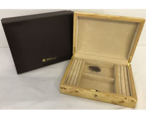 A brand new light birds eye maple jewellery box by Walwood. Interior has two square compartments and ring/earring cushions to