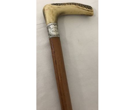 A stag horn handle walking stick with decorative silver collar. Collar engraved J.A.S. Turner Stafford. Hallmarked London 193