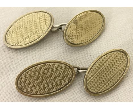 A pair of vintage silver oval cufflinks with engine turned decoration.  