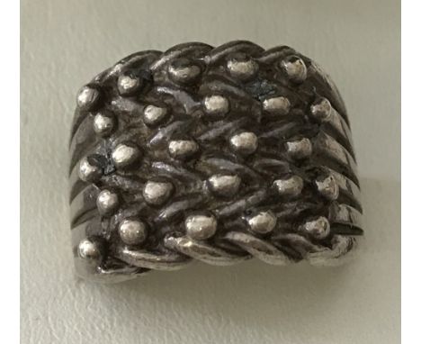 A 925 silver dress ring with woven knot design. Size U. Total weight 13.2g.