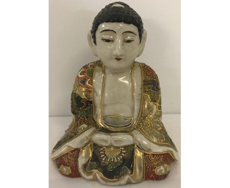 A Kutani ceramic Buddha. Signed to base. 13.5 cm tall.