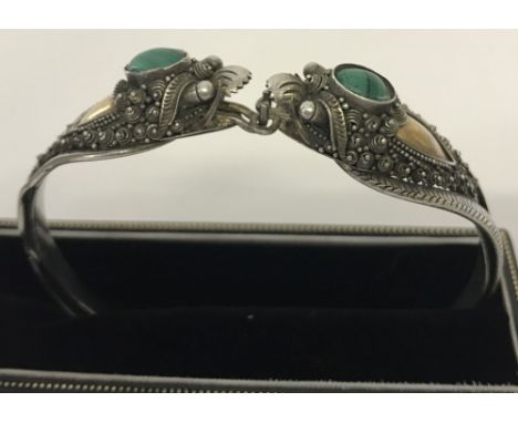 Ornate silver bangle set with malachite in decorative mounts.  