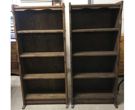 A pair of solid wood vintage dark wood 4 shelf bookcases. Shelves are fixed position. Approx. 67cm wide x 148.5cm tall.